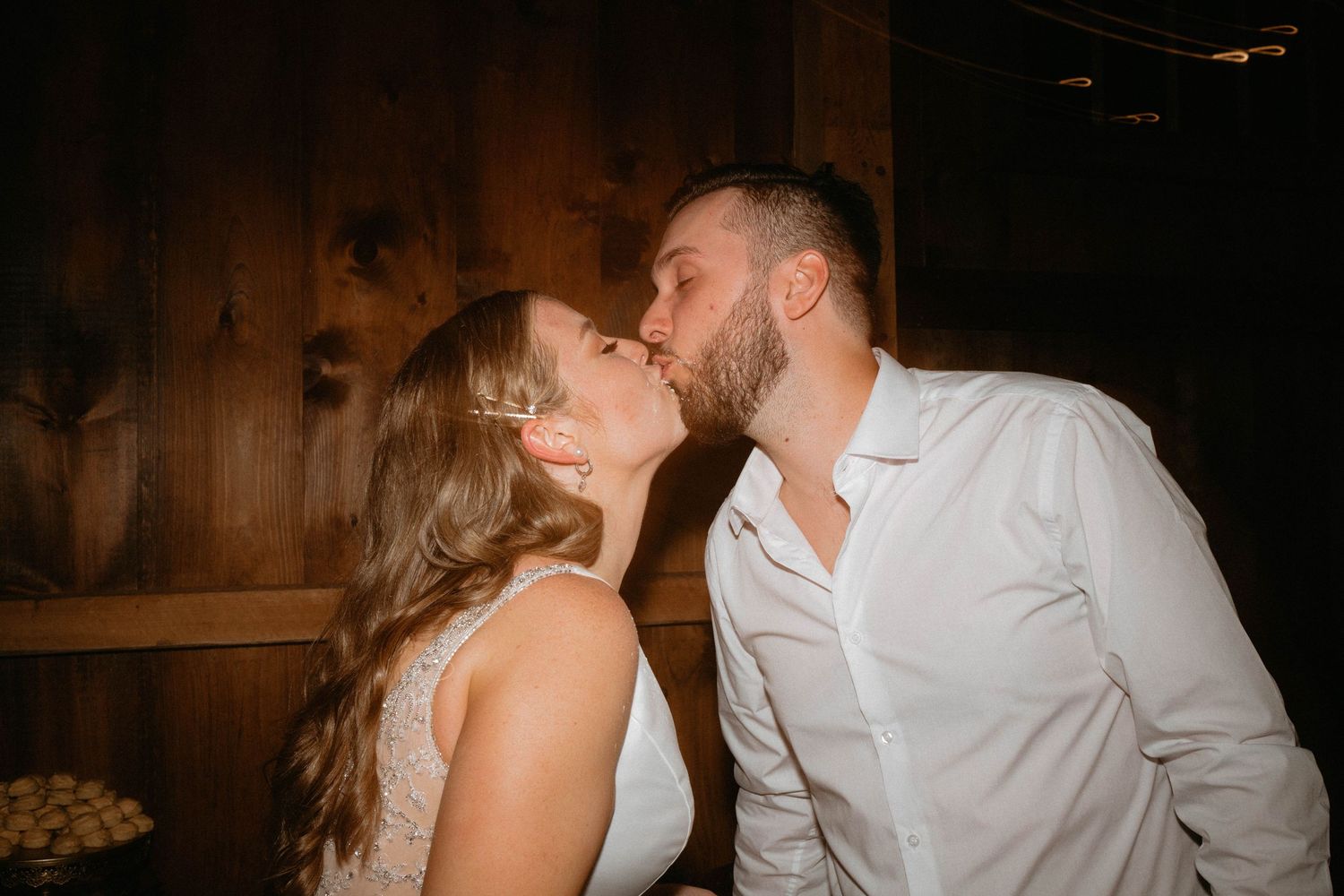 Candid dance party moments at a dimly lit wedding reception.