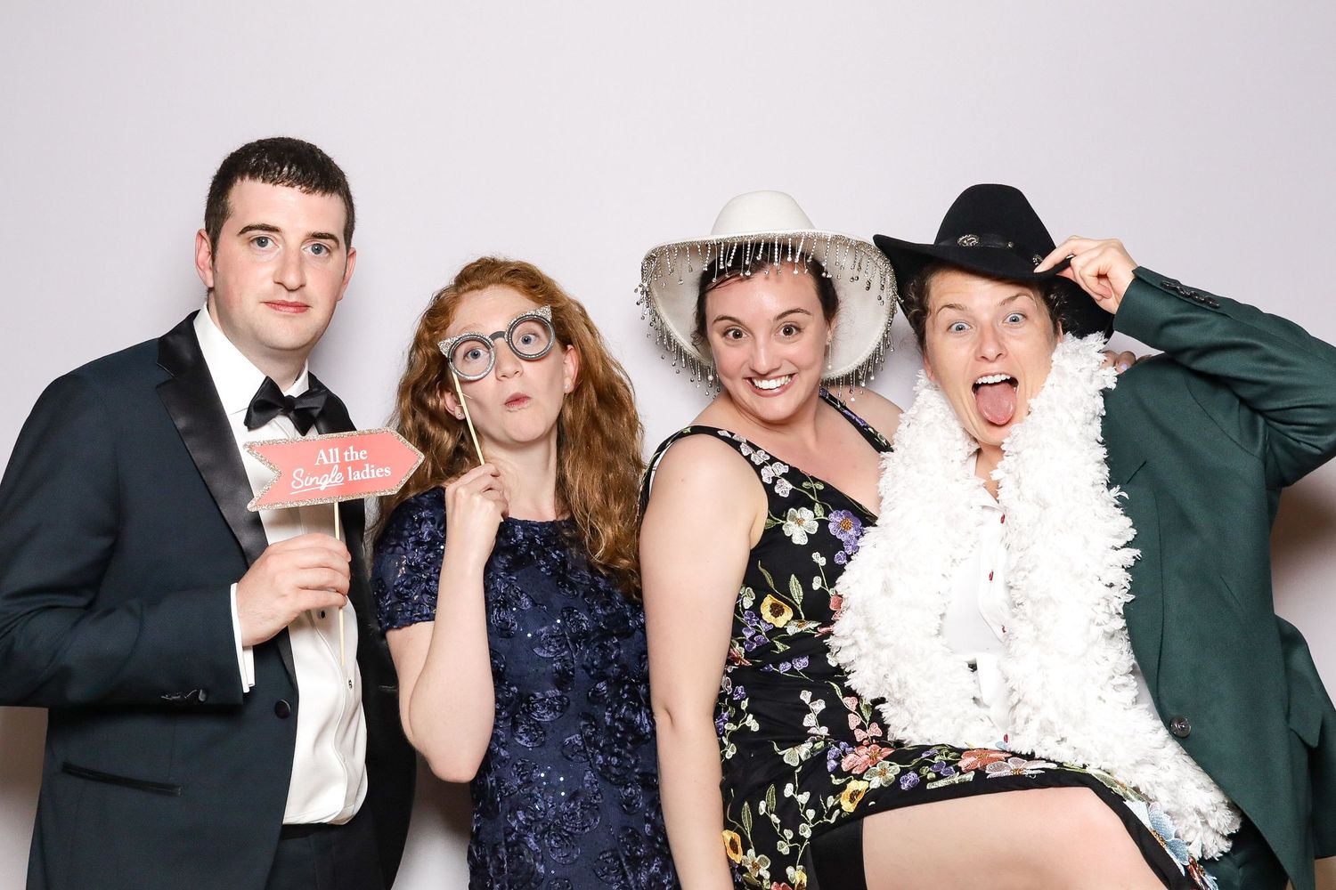 A strip of black and white photo booth style party images showing people posing and having fun together.