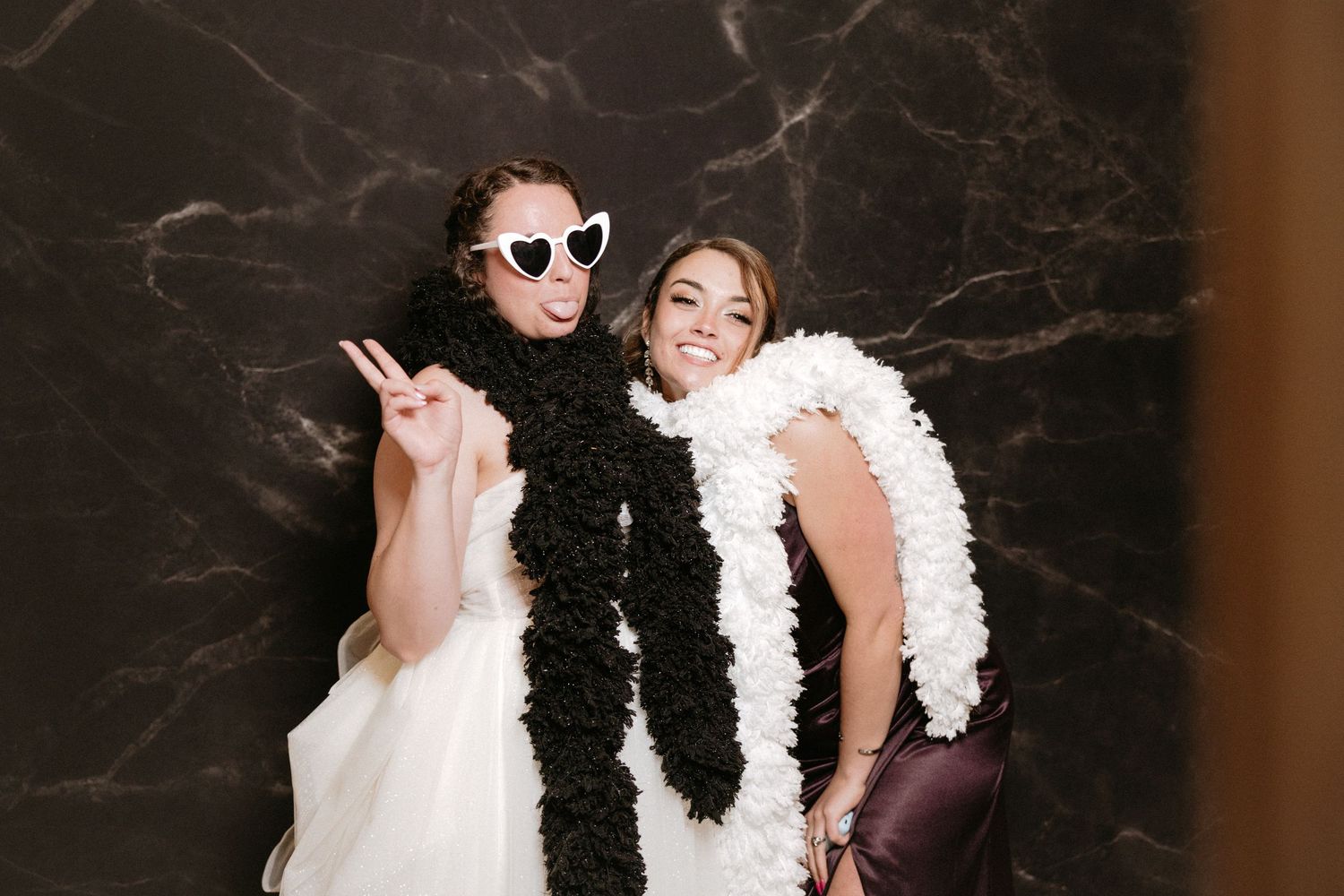 Wedding party poses together with black and white feather boas in a fun photo collage sequence.