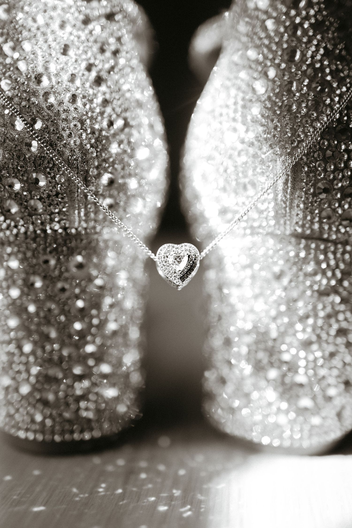 Sparkling silver Christmas ornaments with water droplets creating a magical bokeh effect.