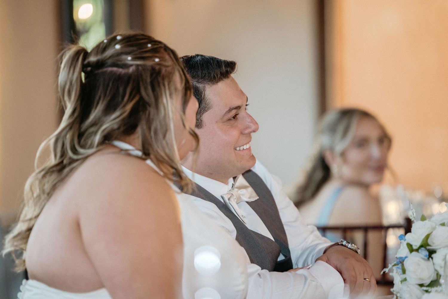 Wedding reception guests gathered together in elegant celebration attire.