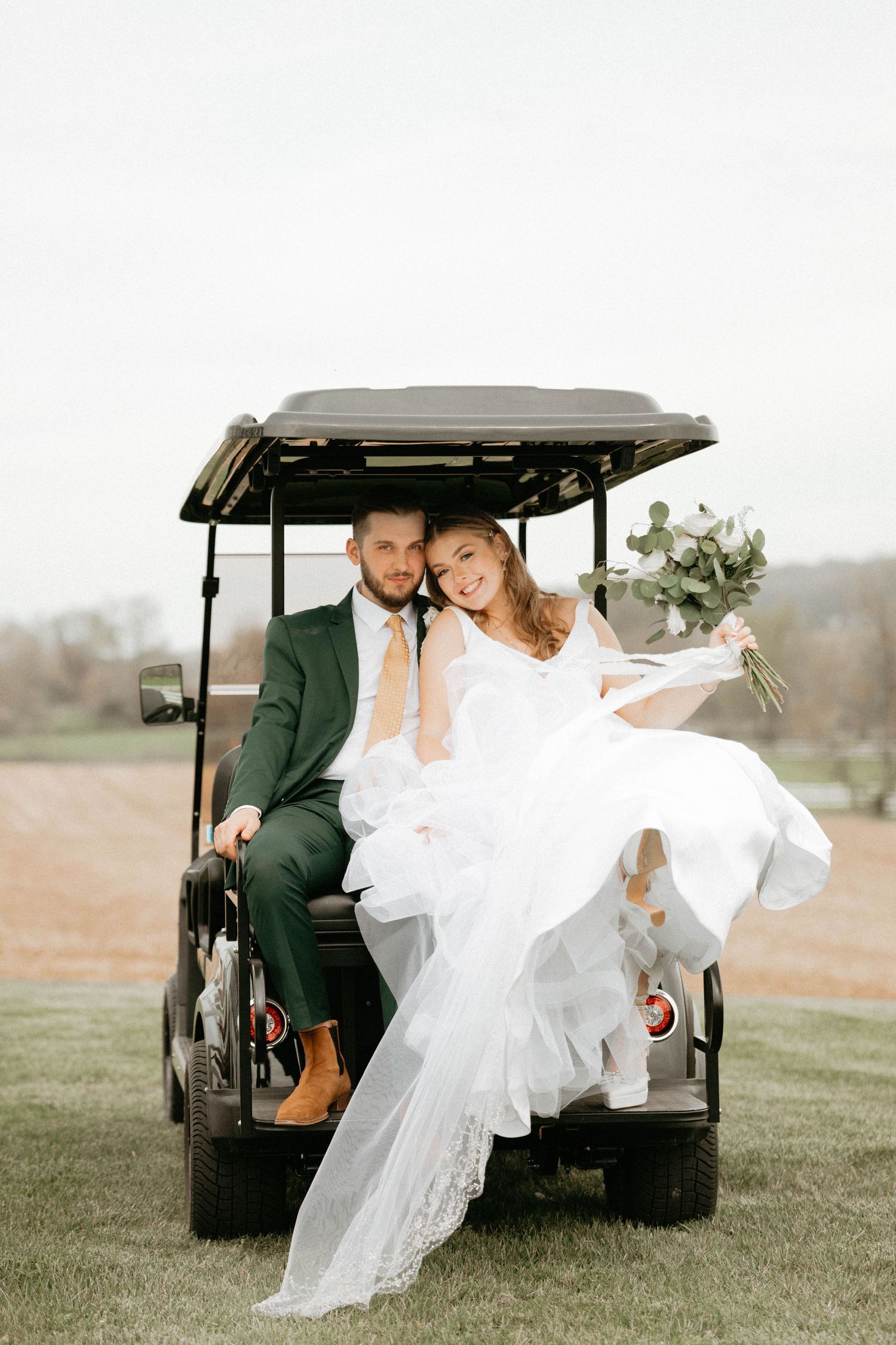 Romantic wedding photos of couple sitting in golf cart with flowing white dress creating elegant poses in outdoor setting.