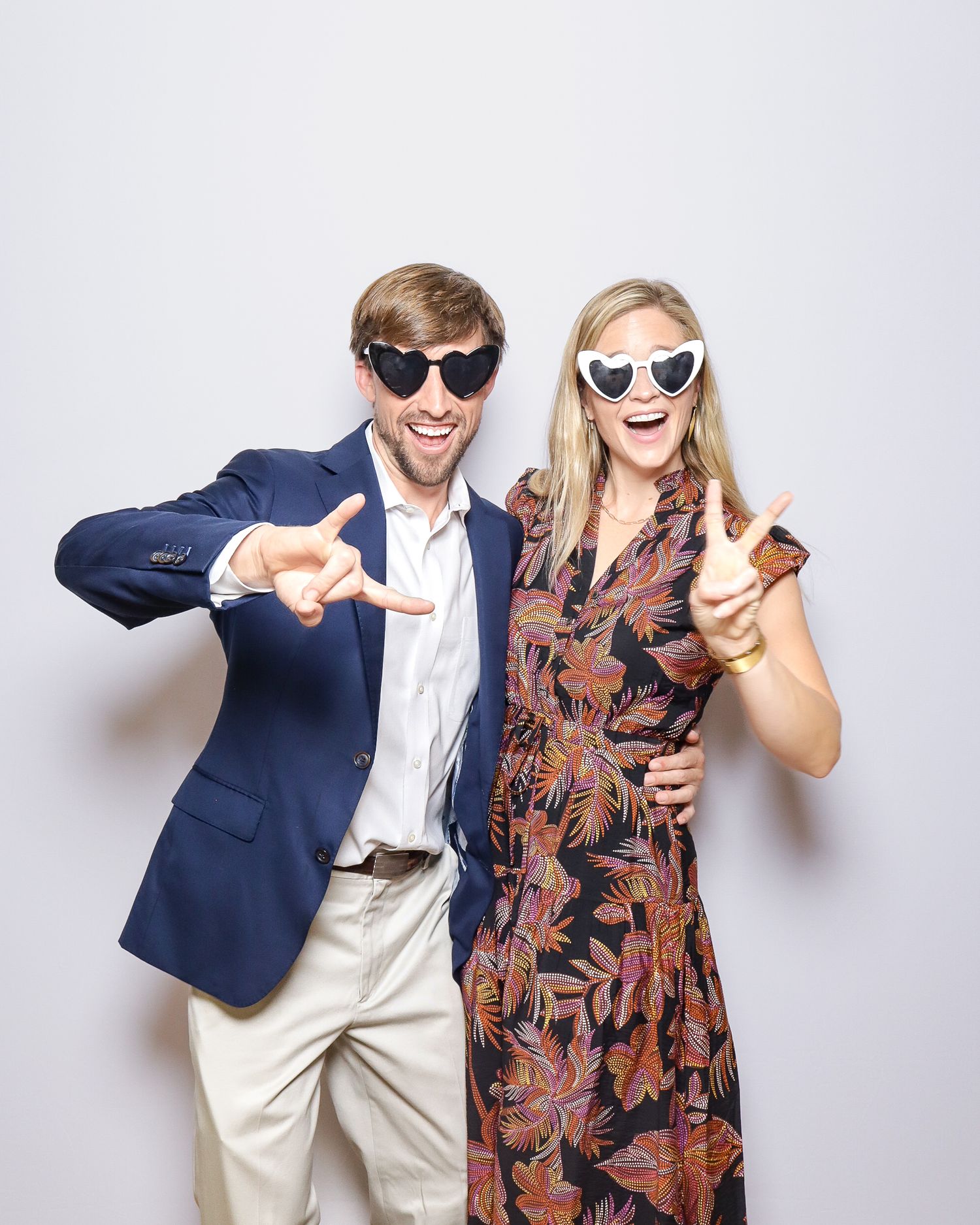 Four candid photos show a couple in formal attire posing playfully against a white background.