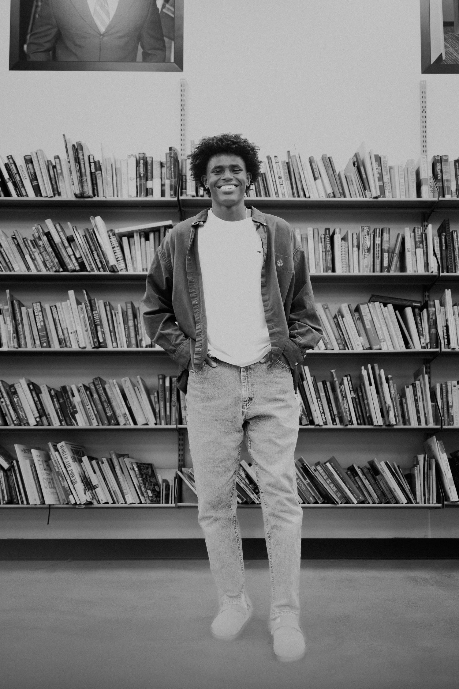 A black and white photo sequence shows a jumping motion captured in five consecutive frames against a library bookshelf background.