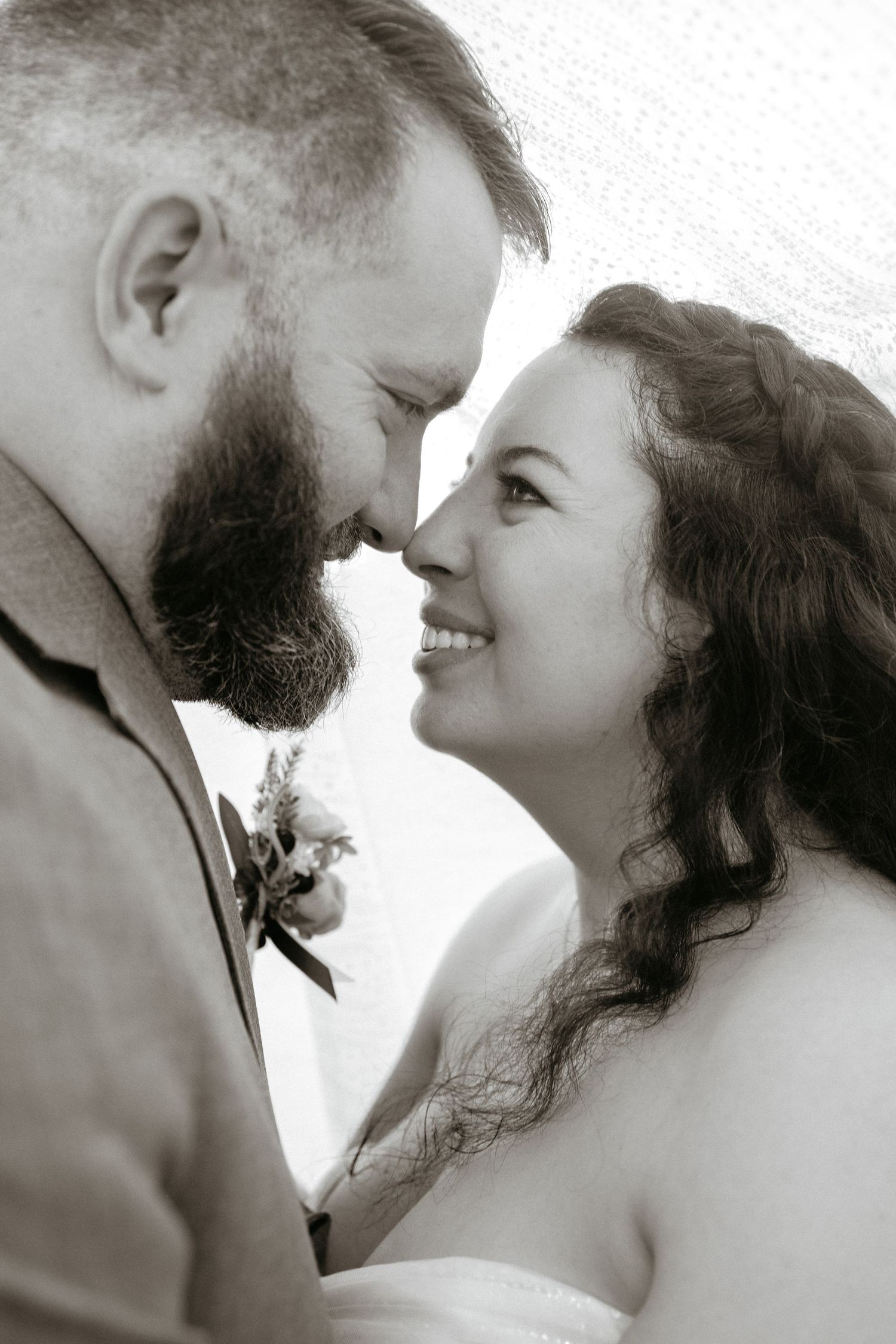 Close up black and white portrait of romantic couple sharing an intimate moment together.