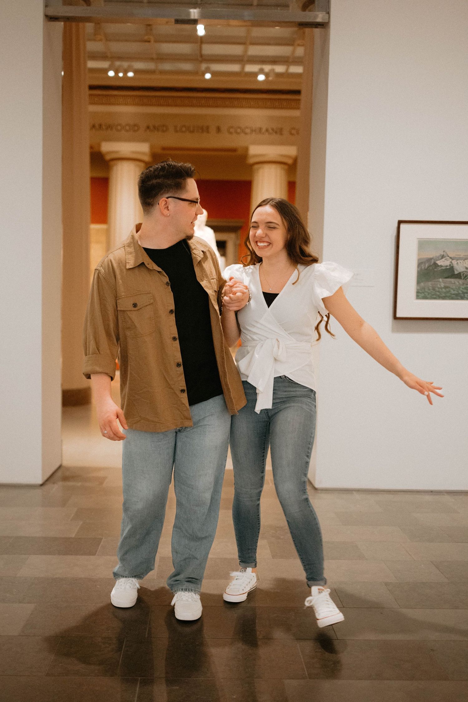 A sequence of candid dance poses shows people having fun in a studio gallery with wooden trim and artwork on walls.