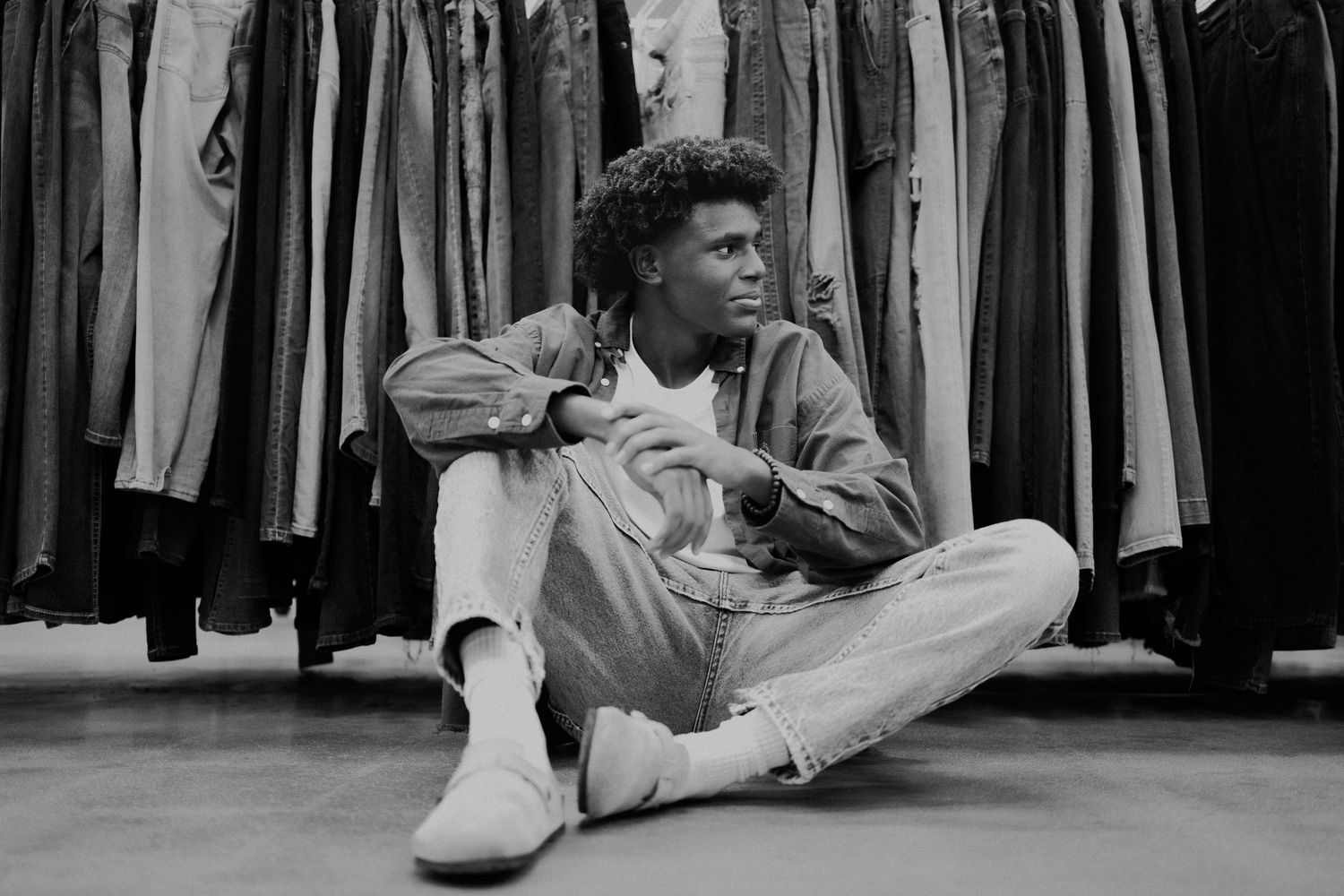 A collection of black and white fashion photos showing someone lounging on the floor in various relaxed poses.
