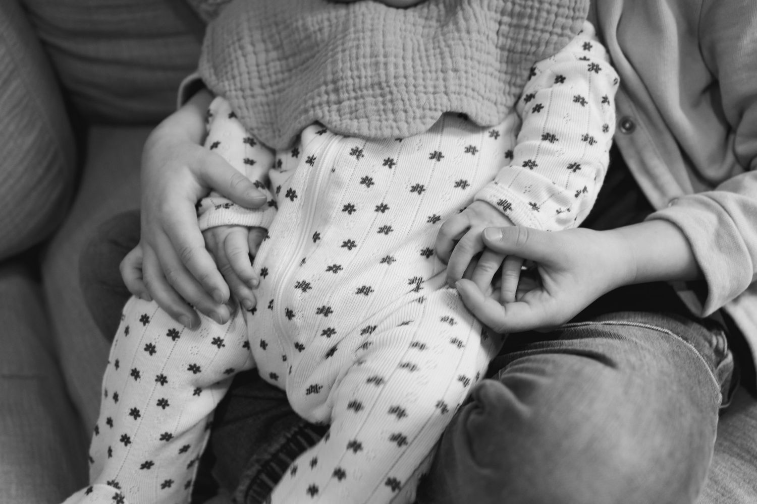 Parents sharing tender moments with their infant while relaxing on a comfortable sofa.