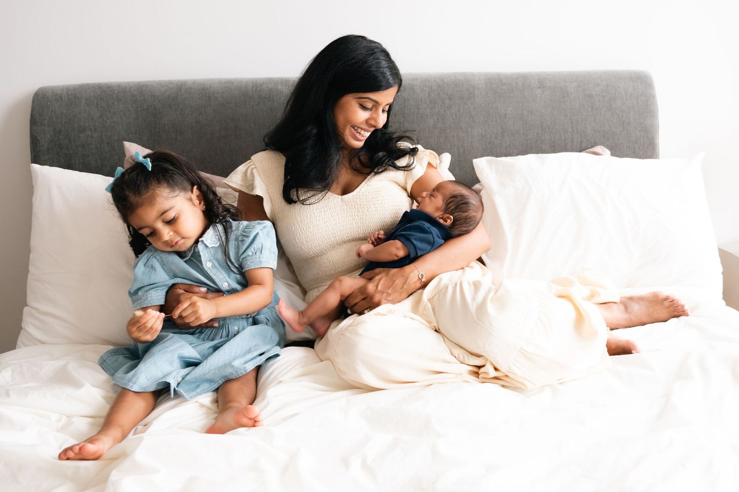A series of tender moments showing a family relaxing together on a white bed.