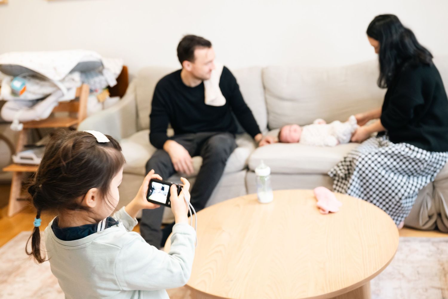 People working together at a long table in a bright office space during a collaborative meeting or workshop session.