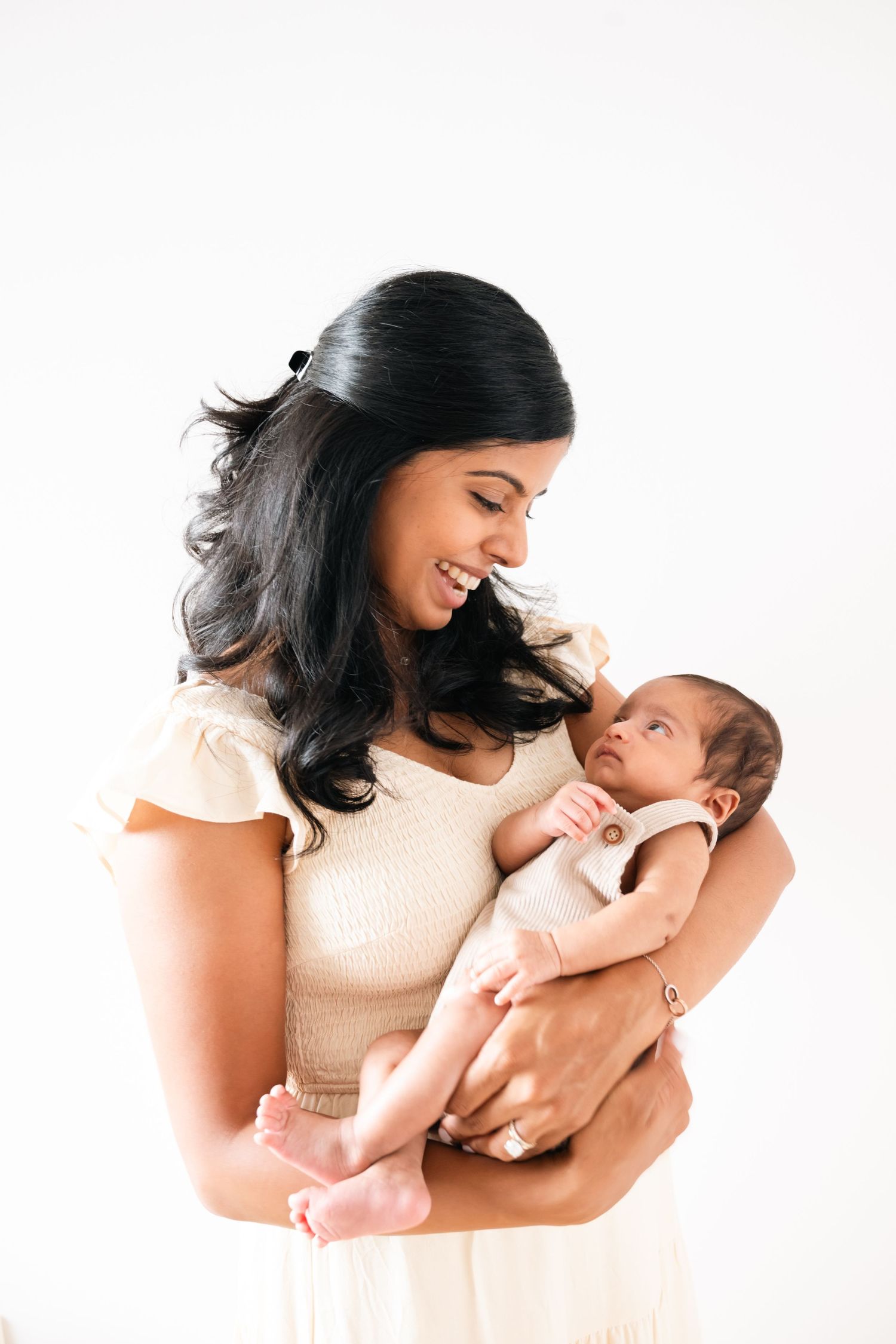 Sweet sequence of mother and newborn baby bonding against white background.
