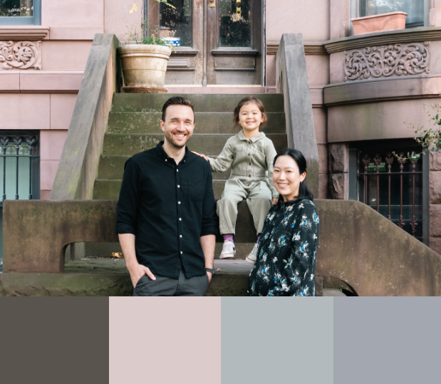 Family portrait session outside historic brownstone building with ornate details.