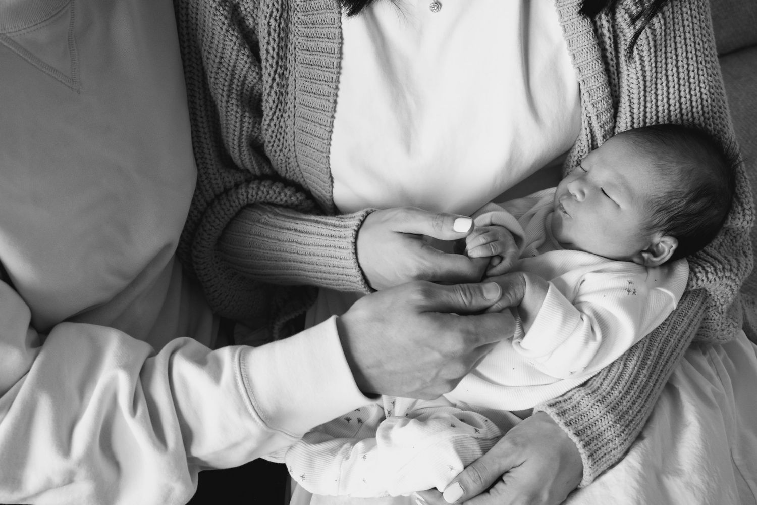 Black and white intimate family portraits showing tender moments.