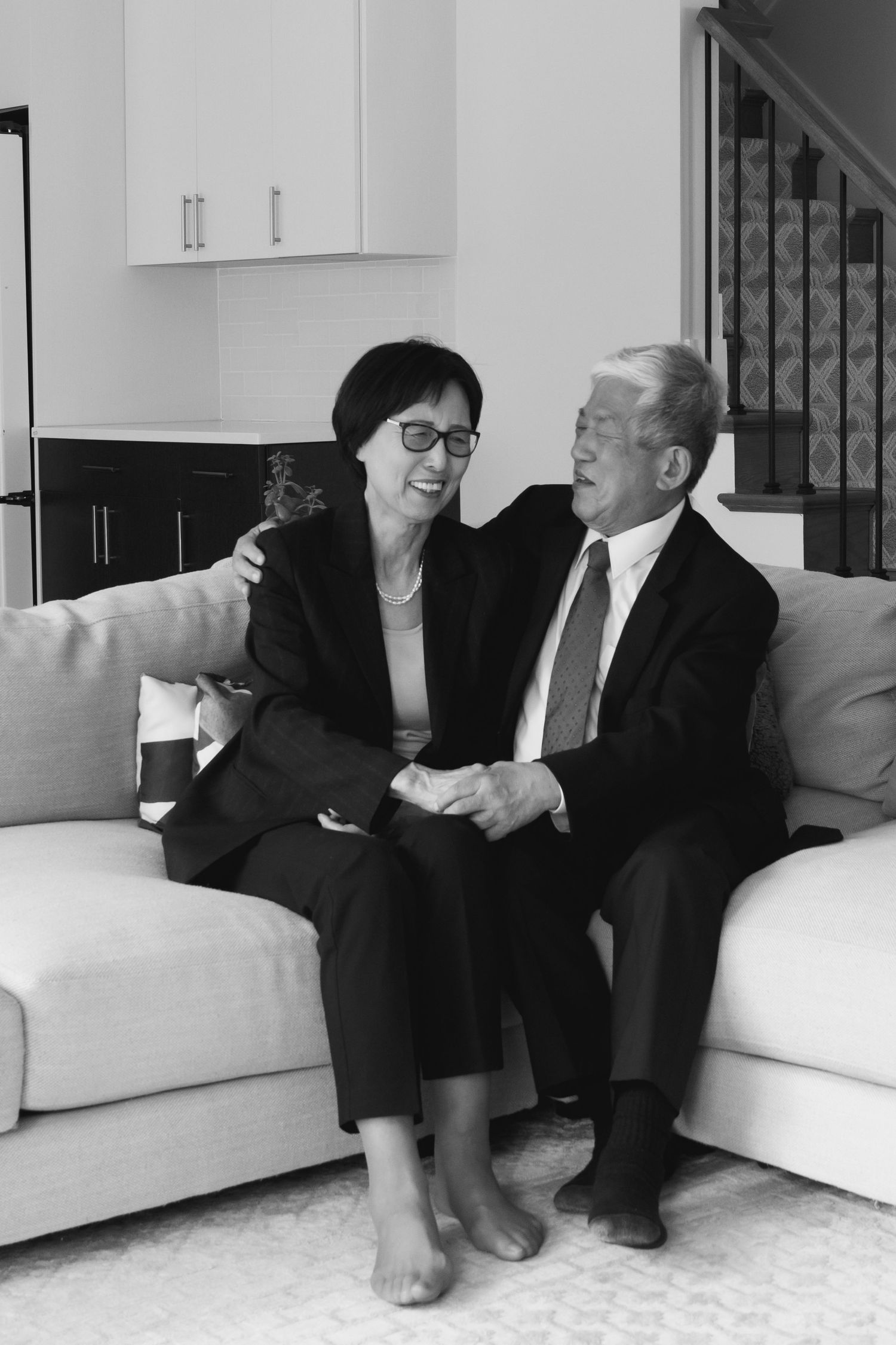 Black and white series showing intimate moments on a white couch.