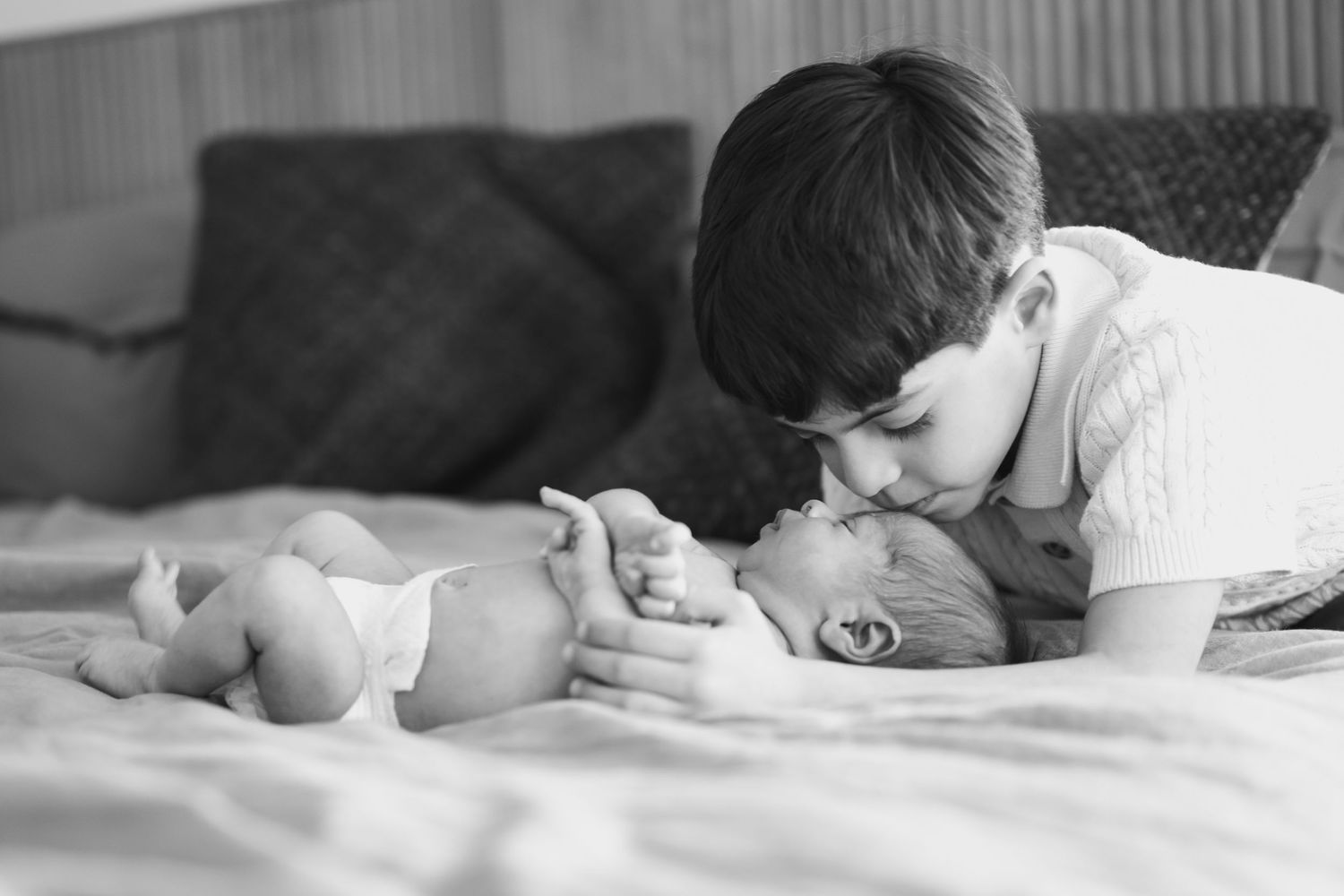 Black and white series of intimate moments during newborn photography session.