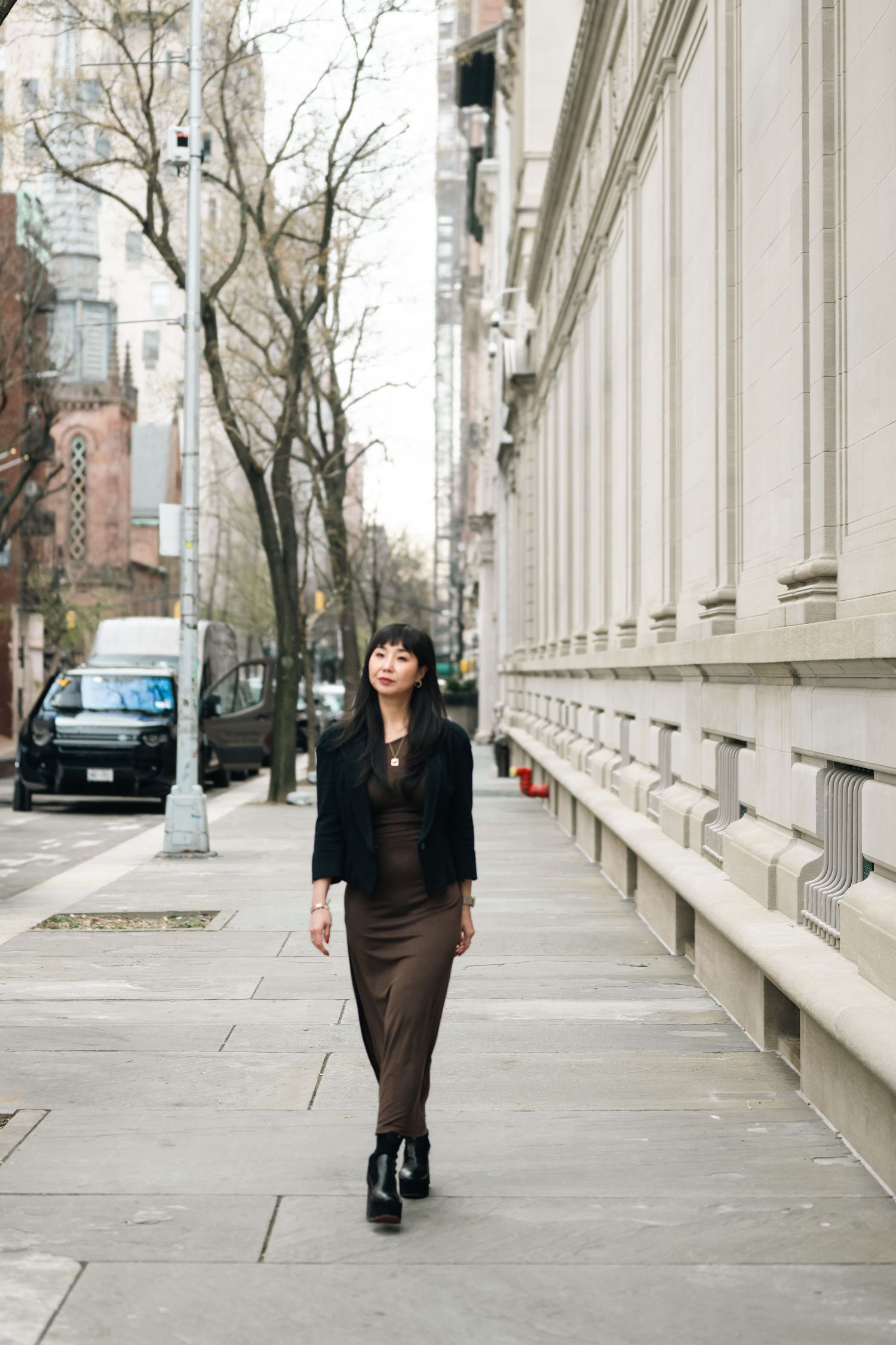 Street scene with architectural columns and urban buildings in the background.