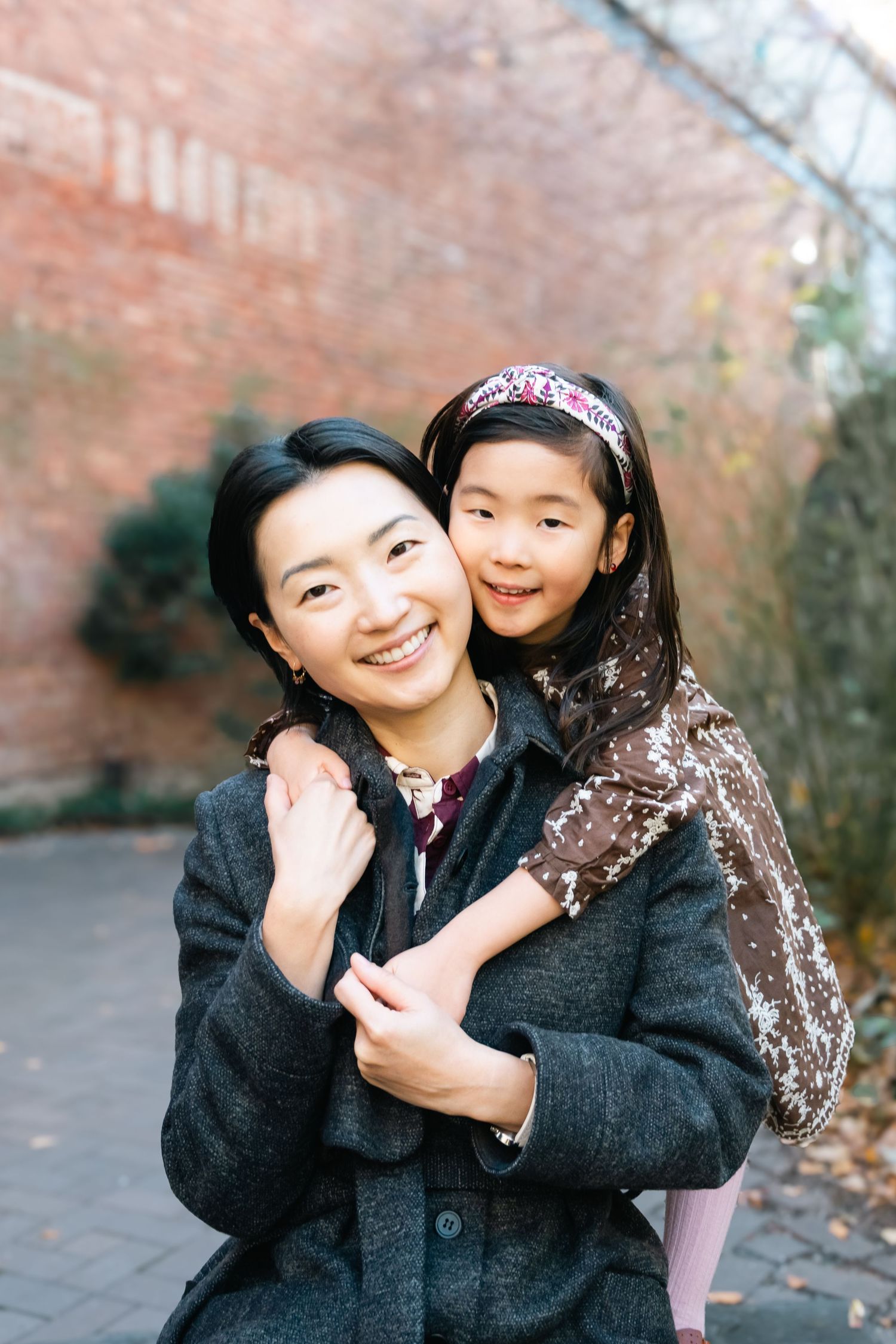 A series of candid photos showing a parent and child embracing and sharing joyful moments together outdoors.