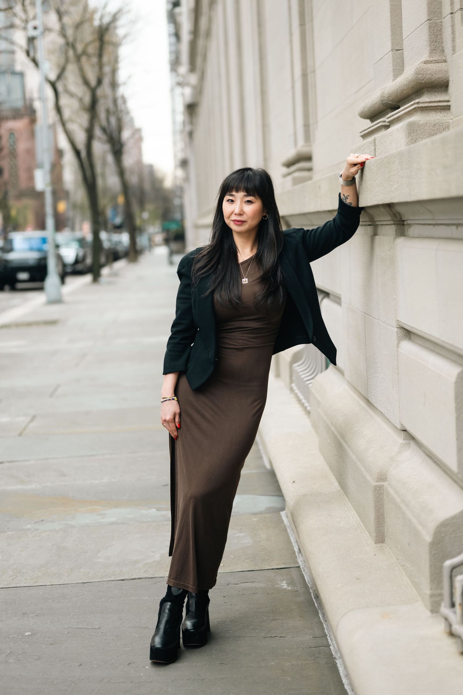 Urban street fashion photography with classic architectural elements.