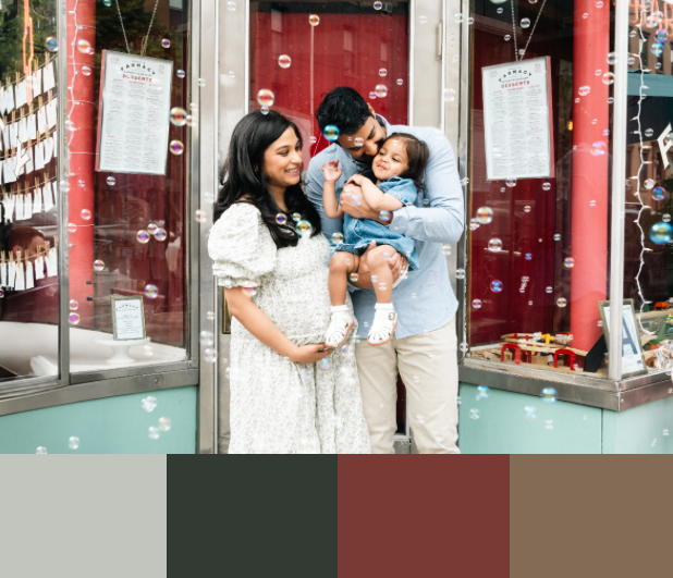 Family sharing joyful moments together in front of red storefront with white signage.