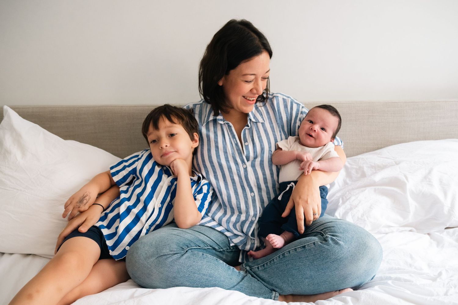 Intimate family lifestyle photos showing relaxed moments together on a bed.