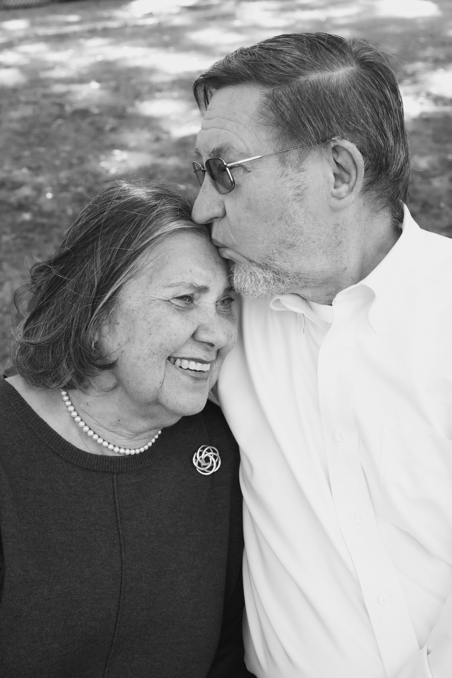 Intimate black and white portrait series of a mature couple sharing tender moments.