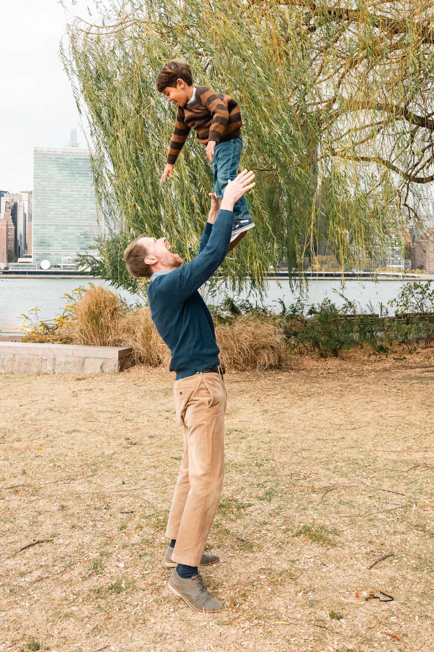 Playful moments captured in sequence at a waterfront park with city views.