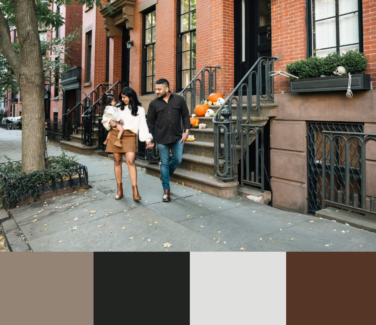 Brownstone buildings with brick facades and iron railings line a residential street.