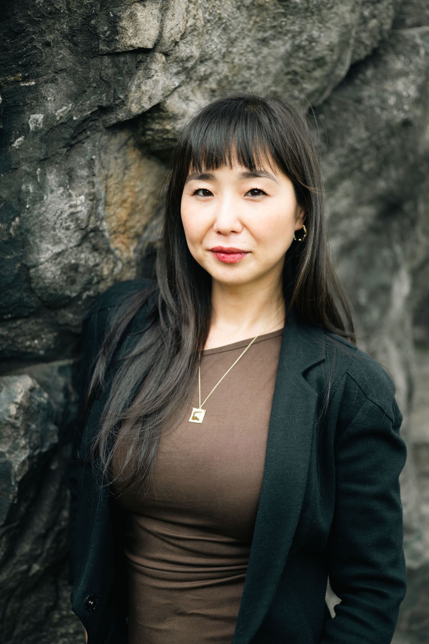 Portrait series against a rocky backdrop wearing business casual attire.