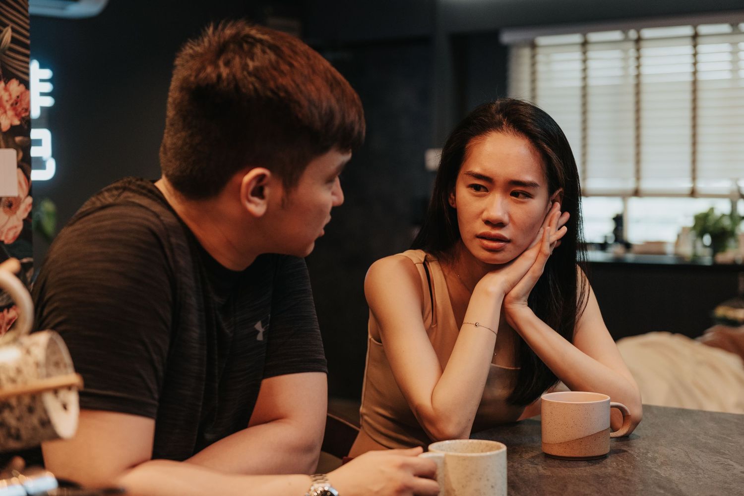 An intimate conversation captured at a modern coffee shop with ambient lighting.