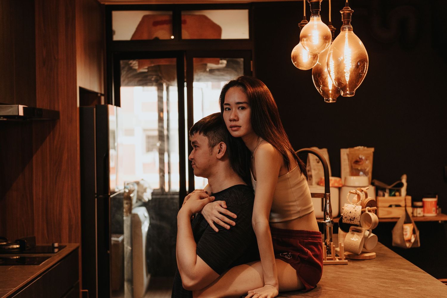 A romantic moment captured in a cozy restaurant setting with warm lighting and wooden accents.