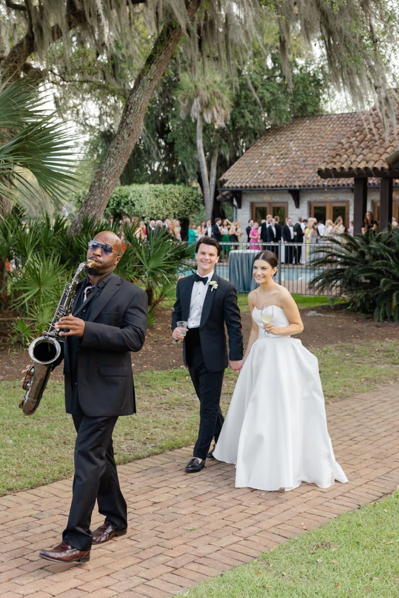 Bride and groom’s reception entrance at Frederica Boathouse on St. Simons Island during a luxury wedding, captured by photographer.