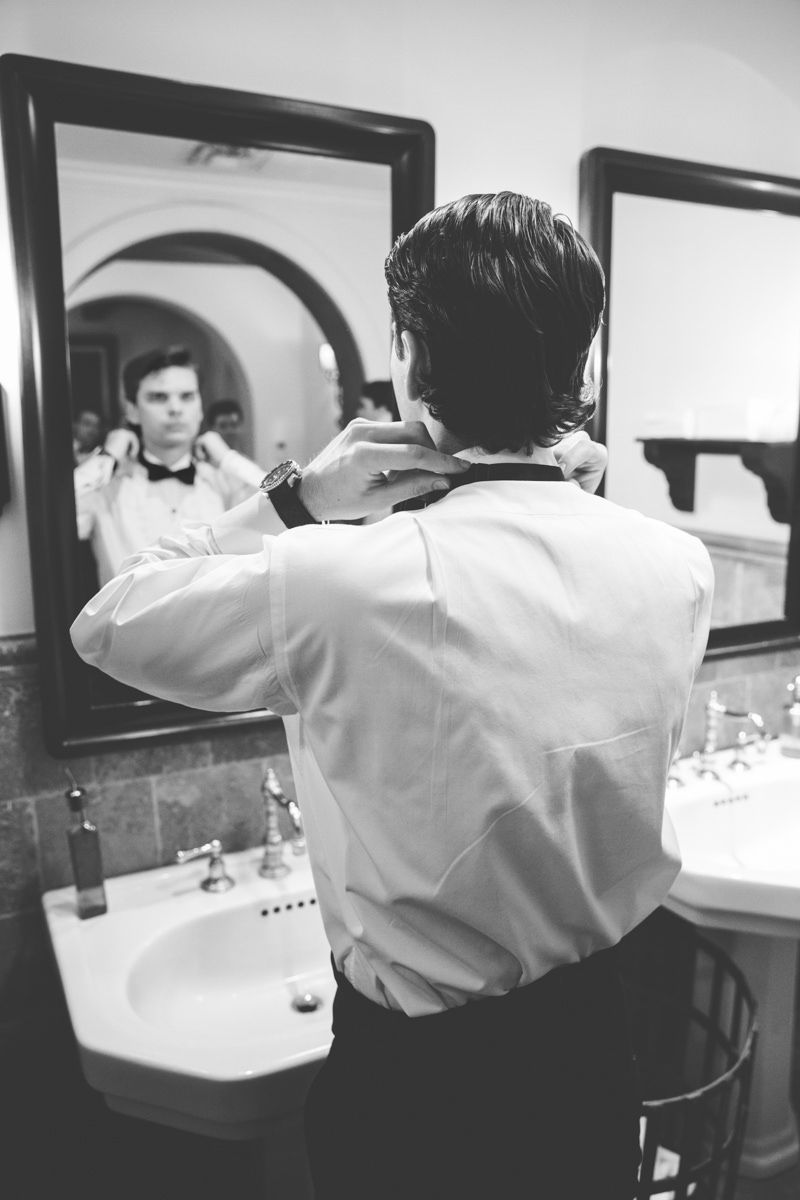 Groom getting ready in the men’s locker room at Sea Island before the wedding, photographed at the Cloister or the Lodge.