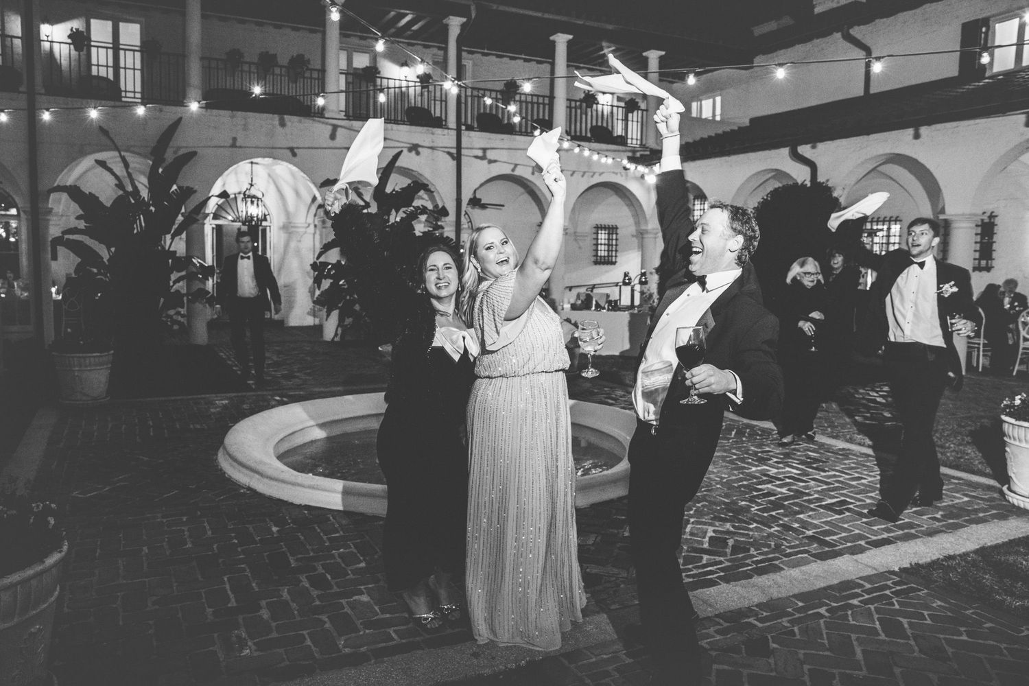 Wedding reception in the Crane Cottage Courtyard at Jekyll Island Club, Georgia—documentary-style photography capturing candid moments.