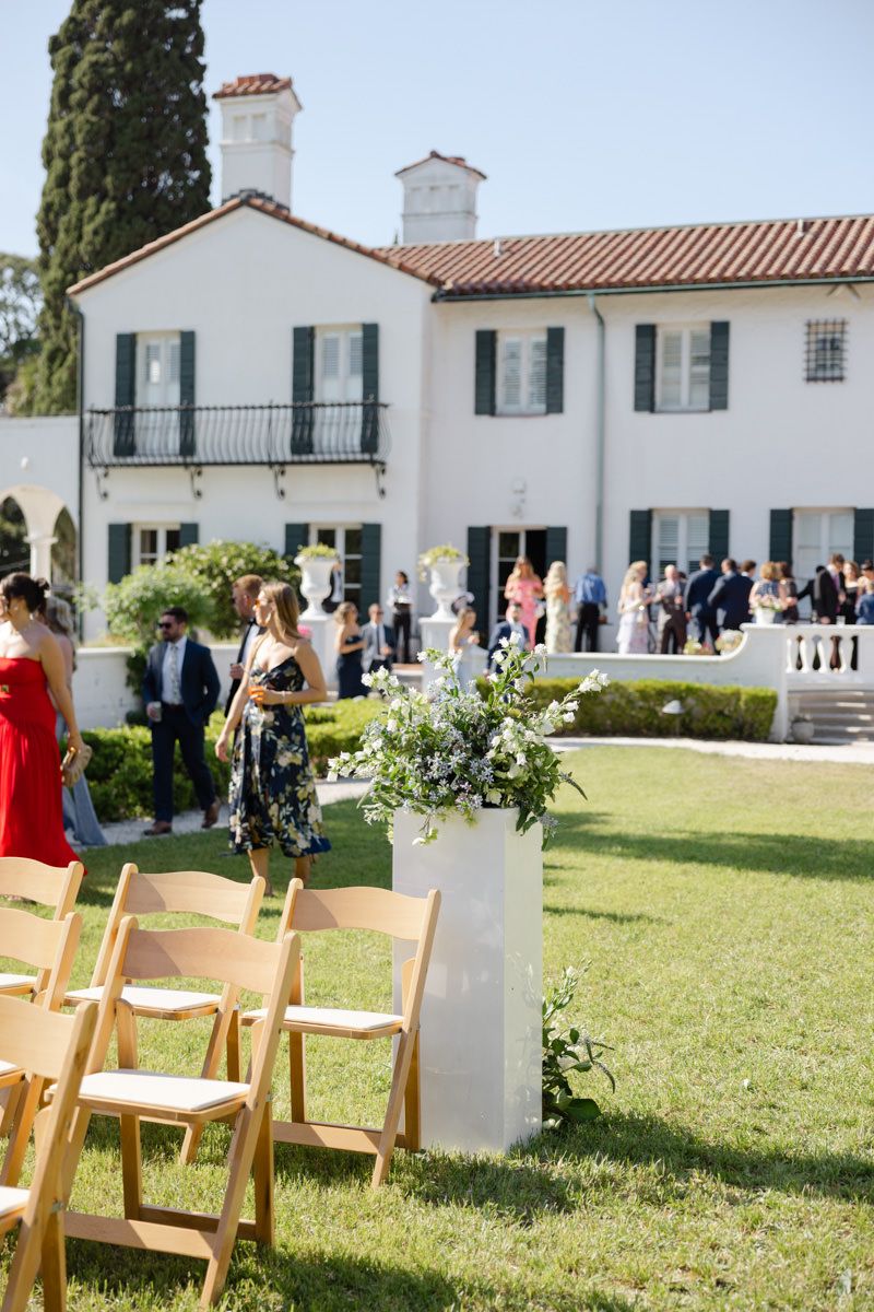 Wedding guests walking into the Sunken Garden ceremony at Crane Cottage on Jekyll Island, captured by wedding photographer.