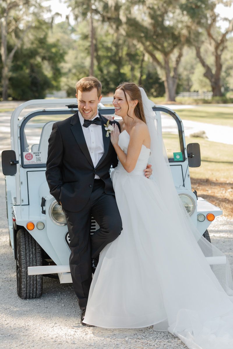 Bride and groom with Moke getaway car at Forbes Farm St. Simons wedding, featuring Island vehicle rental.
