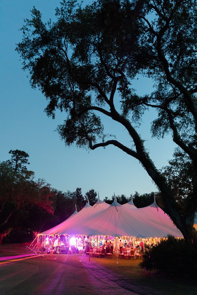 Nighttime photo of a canvas sail tent at The Retreat on St. Simons Island near Sea Island. Elegant coastal wedding setting.