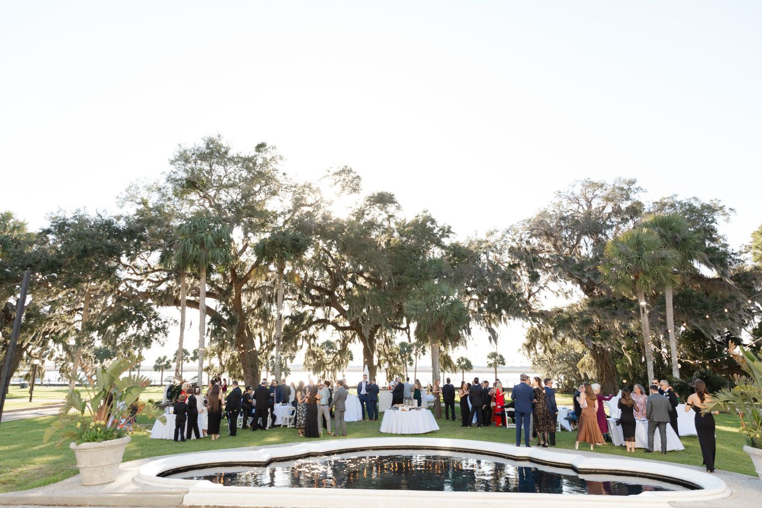 Cocktail reception by the reflecting pool and Riverfront Lawn at Crane Cottage, Jekyll Island Club, Georgia—captured by wedding photographer