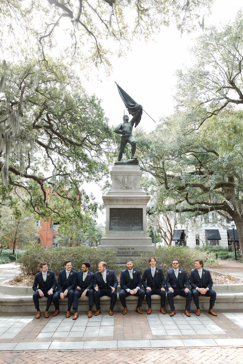 Groomsmen hanging out in historic Savannah square, candid group photo inspo from a modern Georgia wedding.