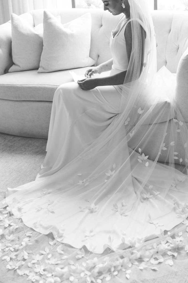 Bride reading a heartfelt letter at Forbes Farm, St. Simons Island wedding with candid, film-style photography vibes.