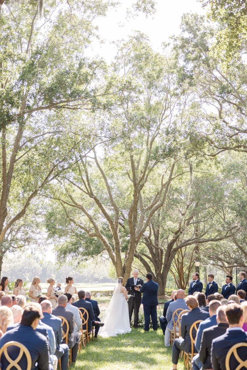 Wedding ceremony at The Retreat, a Sea Island property on St. Simons Island. Elegant outdoor coastal event.