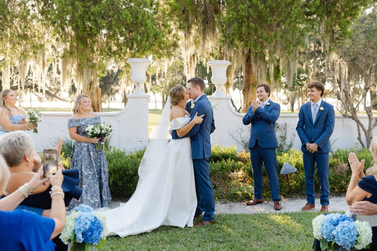 Bride and groom share a “you may kiss the bride” moment during their garden ceremony on Jekyll Island.