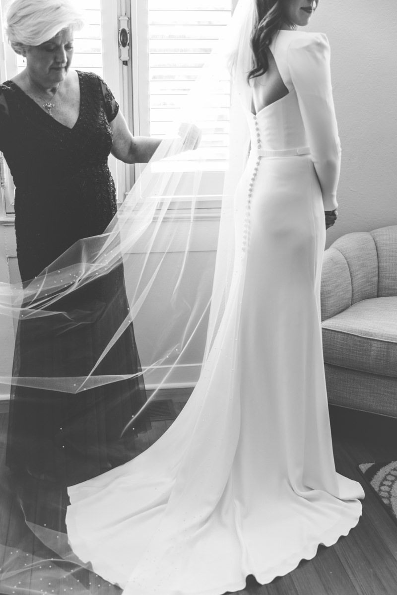 Candid, editorial-style moments of bride getting ready at Jekyll Island Club Resort in Georgia. Documentary wedding photography.