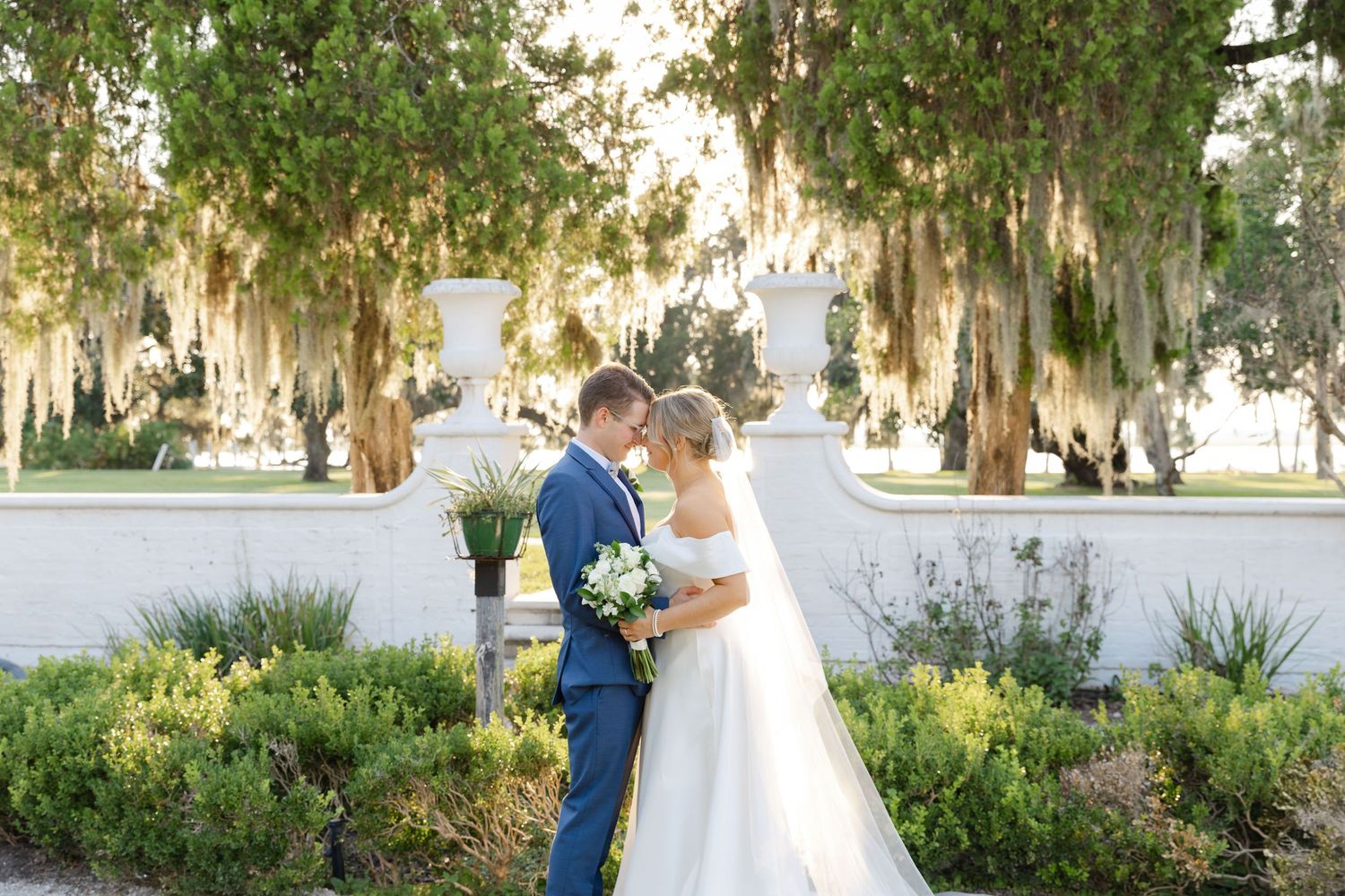 Bride and groom wedding ceremony in the Sunken Garden at Crane Cottage, Jekyll Island—elegant and timeless romantic moment.