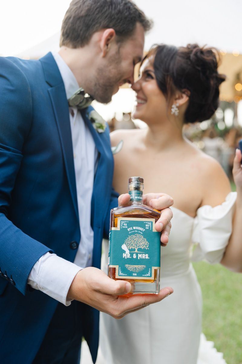 Bride and groom at their Southern wedding on St. Simons Island, celebrating the bourbon bury tradition at Captain’s Bluff.