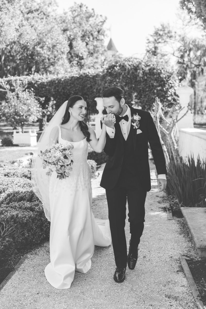 Editorial candid of bride and groom at Jekyll Island Club in the Crane Cottage garden, captured by wedding photographer in the Golden Isles.