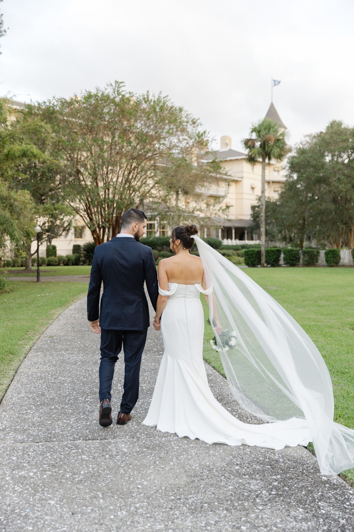 Elegant wedding portraits of bride and groom at Jekyll Island Club Resort hotel, Georgia, captured in fine art and documentary style.