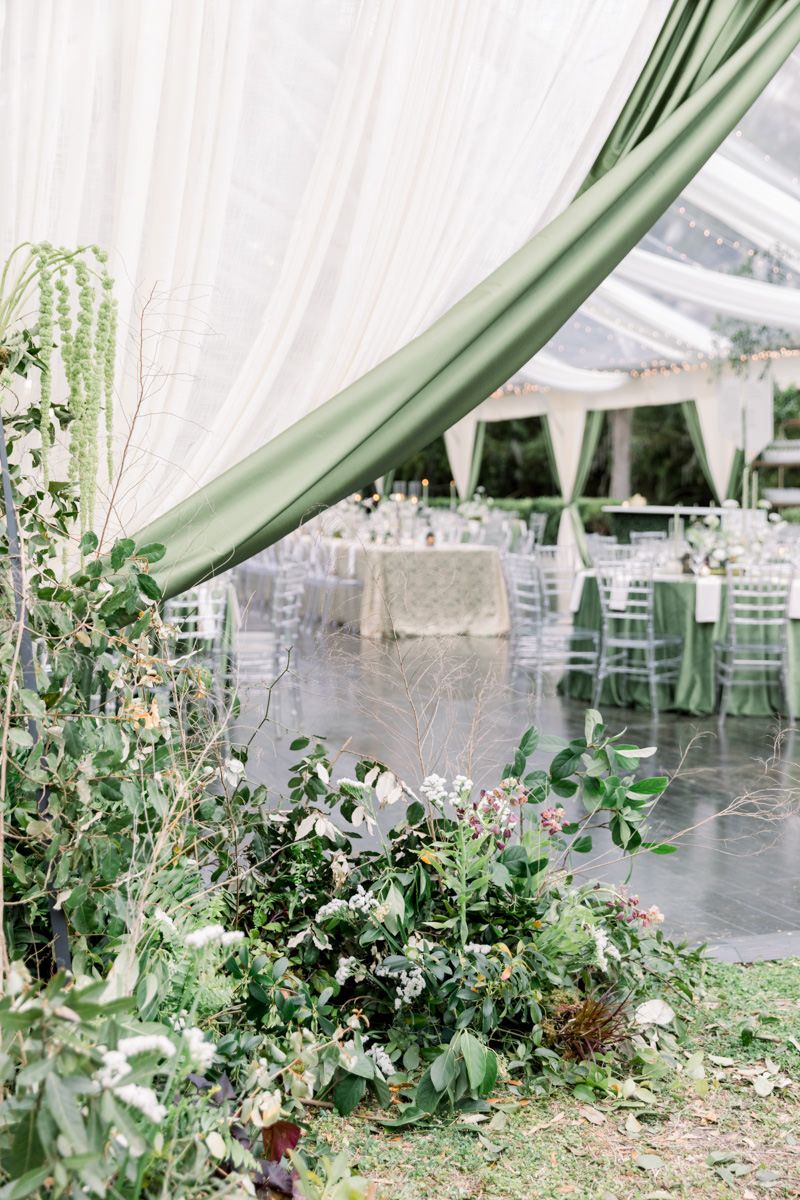 Luxury tented wedding on Sea Island, Georgia with abundant floral design and high-end details, captured by wedding photographer.