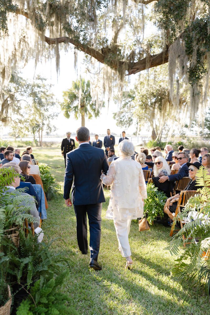 Wedding ceremony under oak moss by the marsh at Captains Bluff on St. Simons Island, captured by wedding photographer in Georgia.