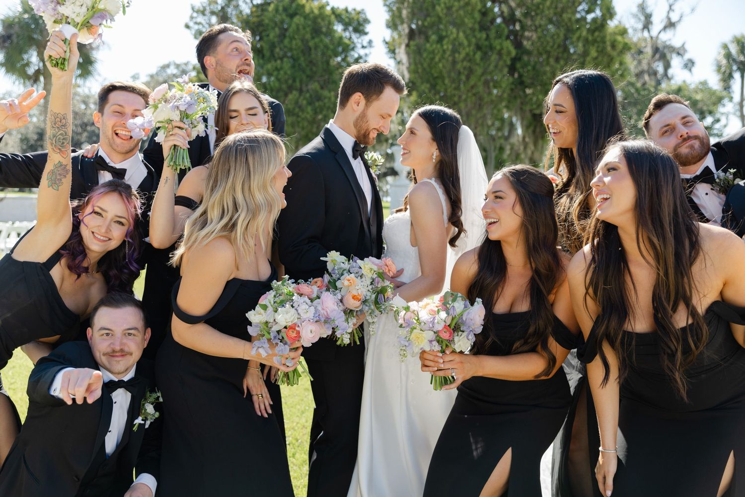 Bride and groom with wedding party in candid, documentary-style portraits on Jekyll Island, timeless and natural wedding photography.