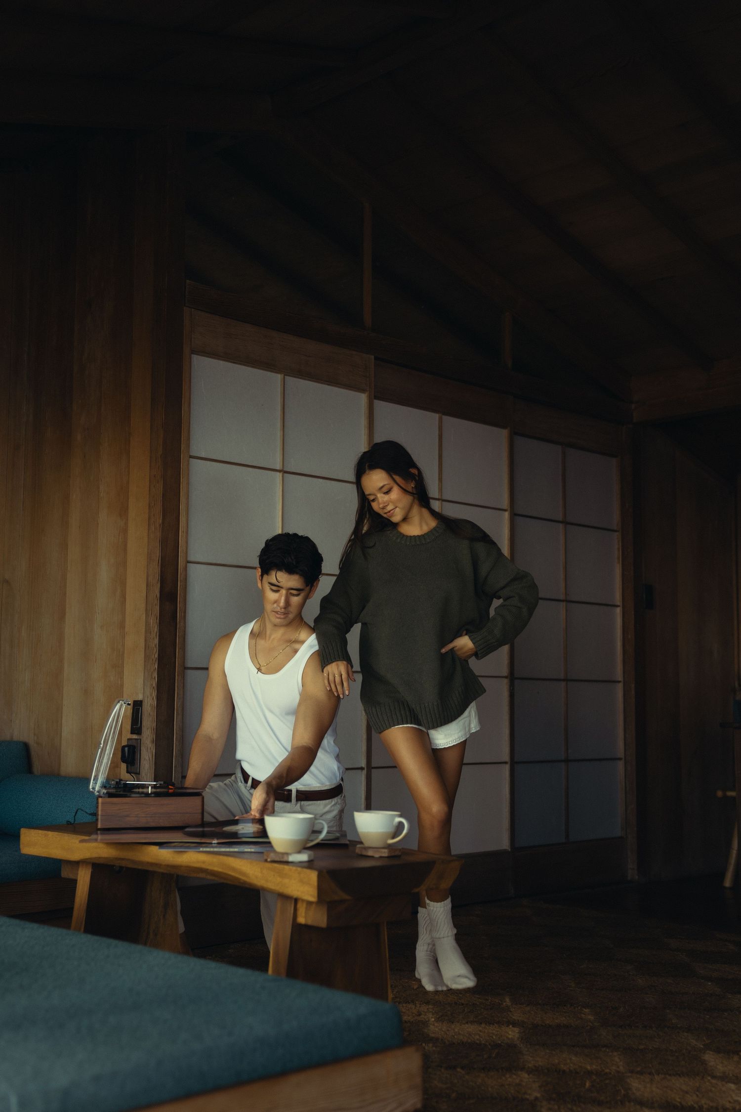 Couple preparing tea ceremony in modern Japanese-inspired interior.